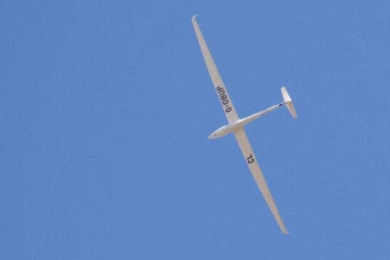 Looking up from our garden, a glider climbs a thermal.